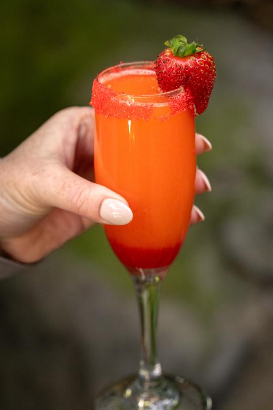 Strawberry mimosa cocktail in a champagne flute