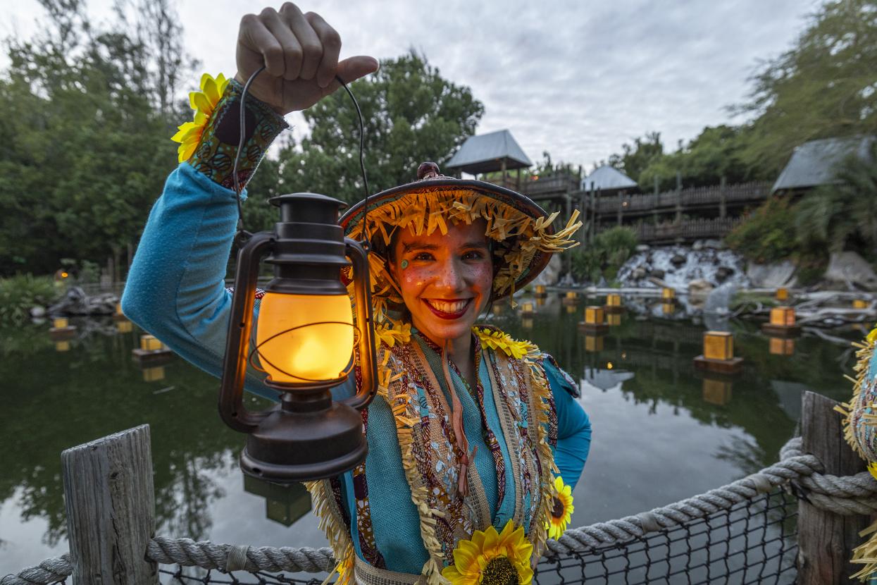 Scarecrow holding lantern