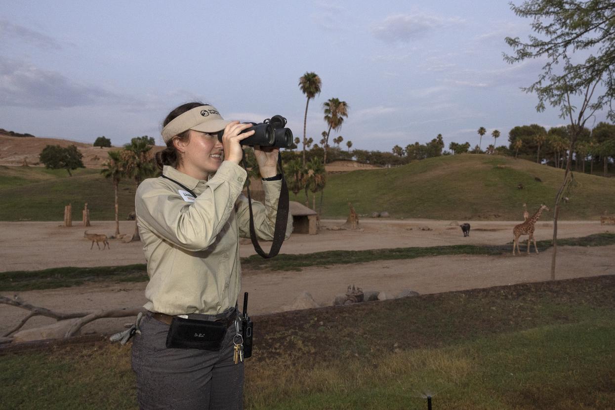 Woman using binoculars.